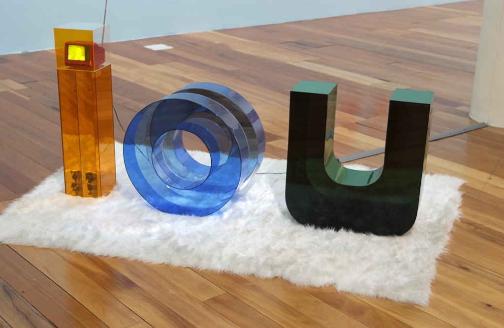 IOU, coloured acrylic sheeting, synthetic rug, television 800 x 2000 x 1500 mm